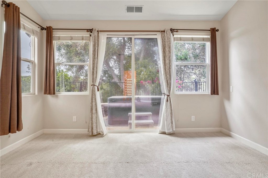 569 Inverlochy Drive Fallbrook, CA 92028 - Photo 17 of 36 an empty room with windows and an outdoor view