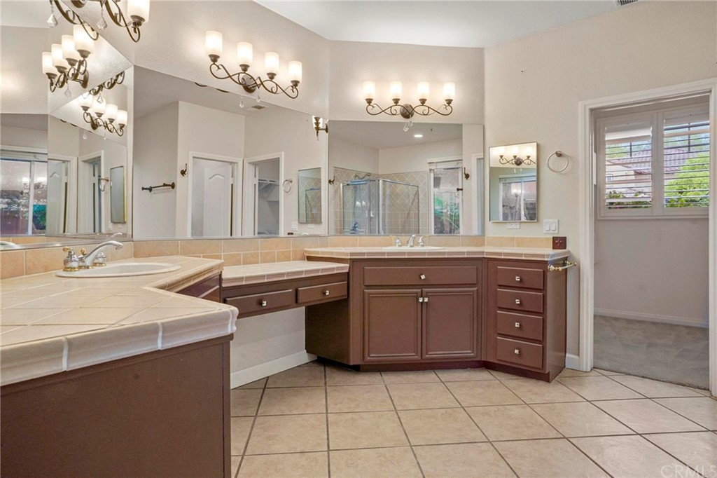 569 Inverlochy Drive Fallbrook, CA 92028 - Photo 20 of 36 a room with a cabinets and chandelier