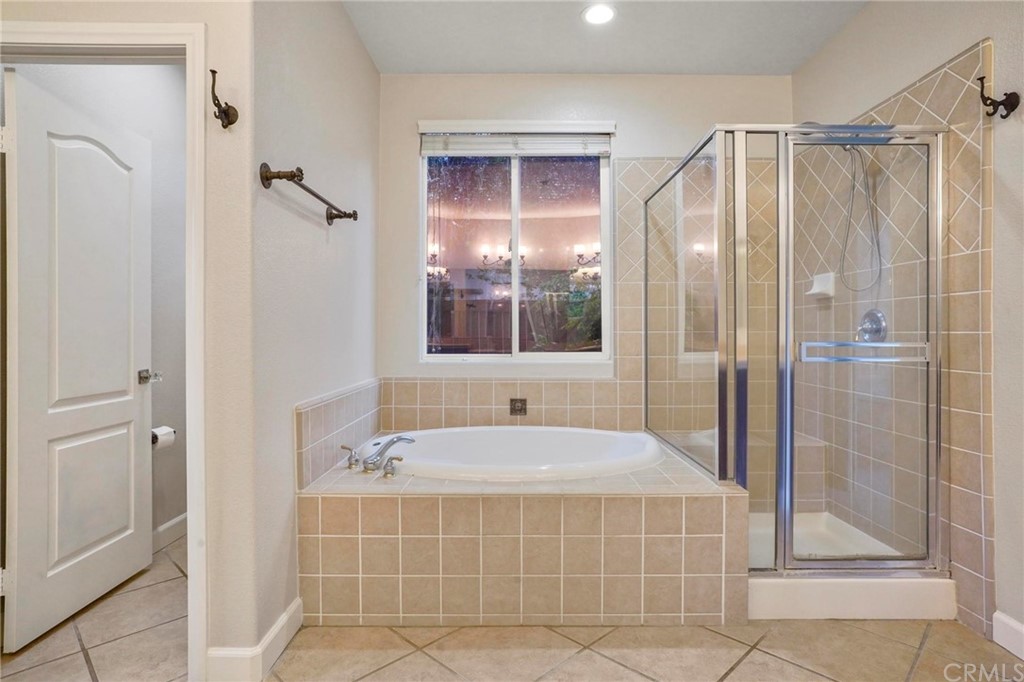 569 Inverlochy Drive Fallbrook, CA 92028 - Photo 21 of 36 a bathroom with a tub and a shower