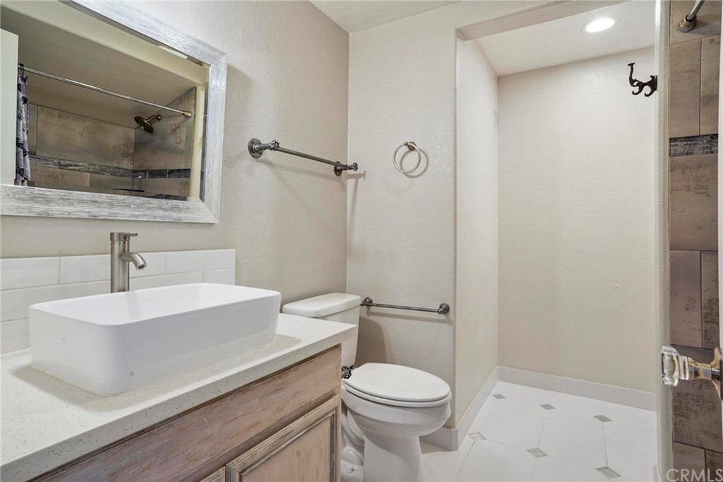 569 Inverlochy Drive Fallbrook, CA 92028 - Photo 26 of 36 a bathroom with a sink a toilet and shower