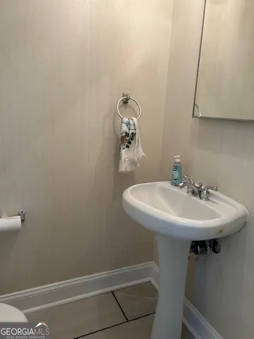 a white toilet sitting next to a white sink