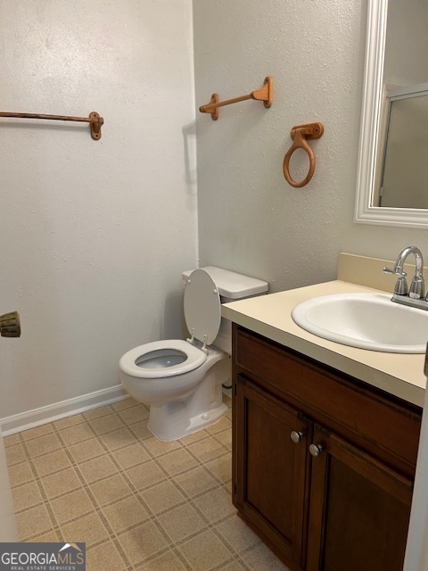 295 Handley Court Tyrone, GA 30290 - Photo 20 of 25 a bathroom with a sink a toilet and a mirror