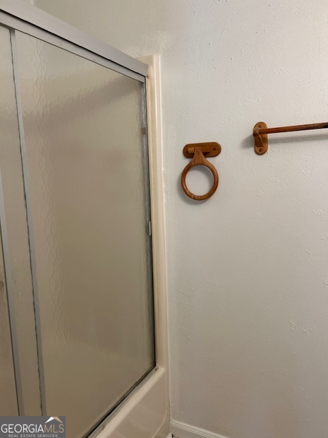 295 Handley Court Tyrone, GA 30290 - Photo 22 of 25 a bathroom with a glass shower door