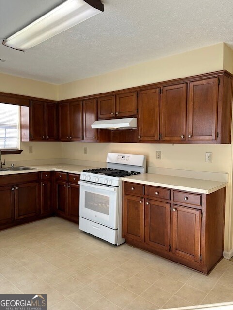 295 Handley Court Tyrone, GA 30290 - Photo 8 of 25 a kitchen with stainless steel appliances granite countertop a stove cabinets and a sink