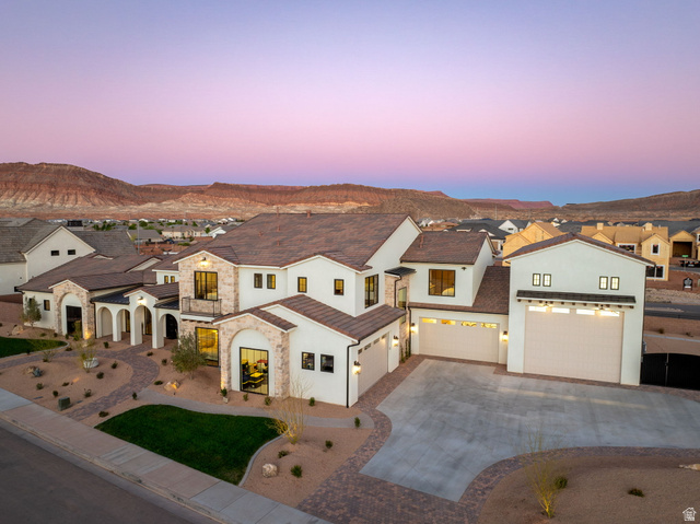 4871 South Homestead Way Washington, UT 84780 - Photo 129 of 151 View of front of property featuring a residential view, concrete driveway, stucco siding, stone siding, and a mountain view