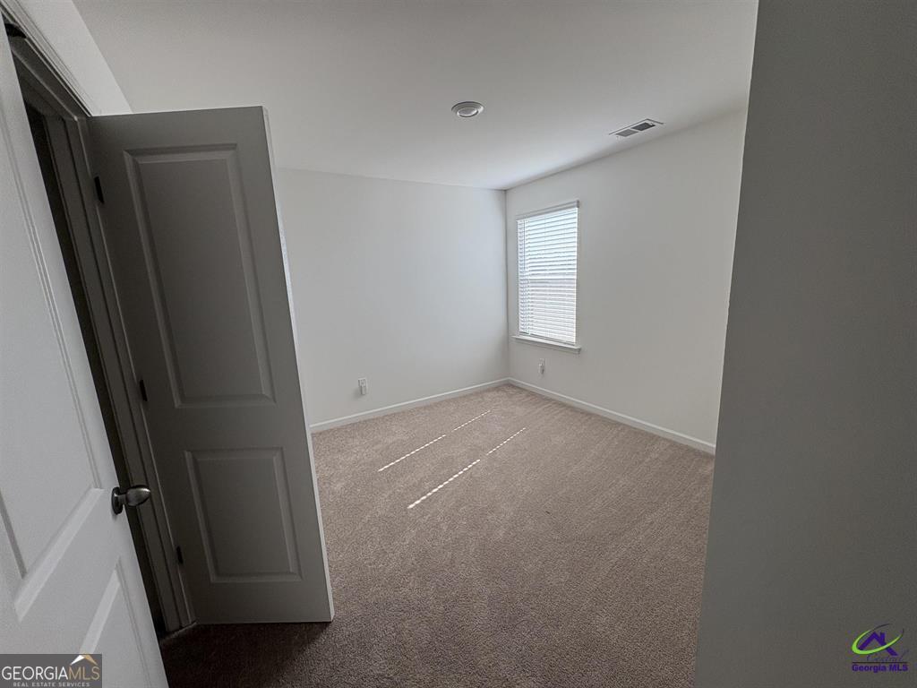 1100 Holland Drive Hampton, GA 30228 - Photo 12 of 15 an empty room with windows