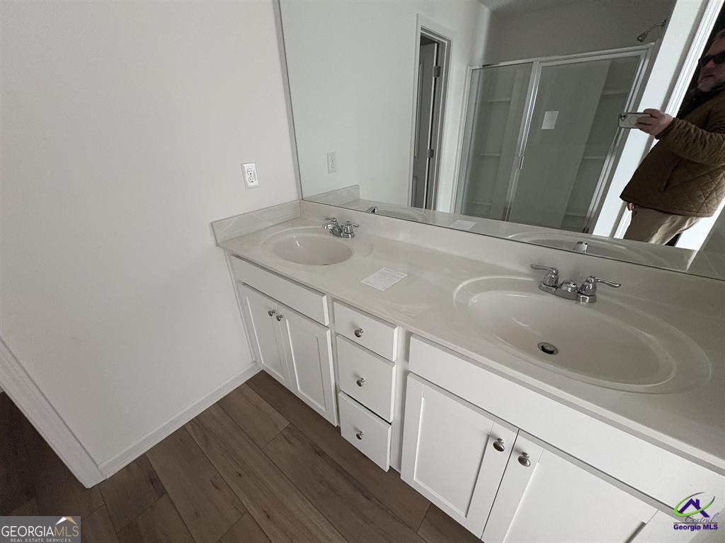 1100 Holland Drive Hampton, GA 30228 - Photo 13 of 15 a bathroom with a double vanity sink and mirror