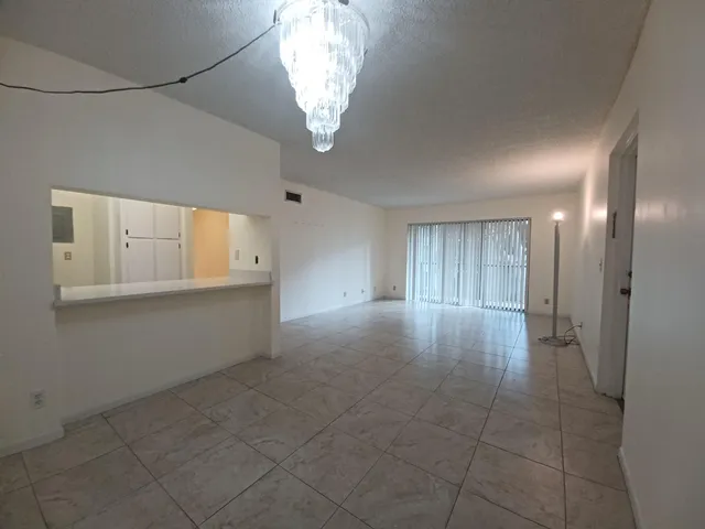 a view of an empty room with a chandelier