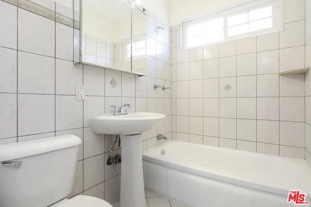 a bathroom with a sink a toilet and bathtub