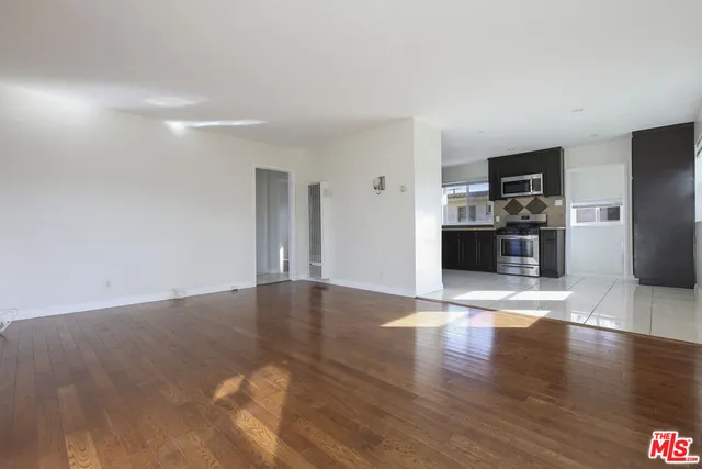 a view of a kitchen with a sink and a refrigerator