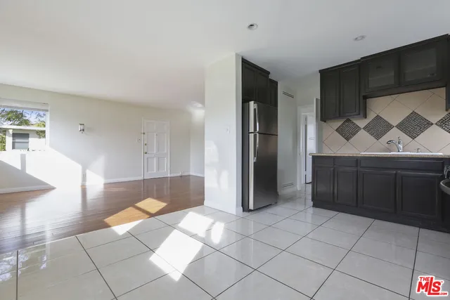 a view of kitchen with furniture and a refrigerator