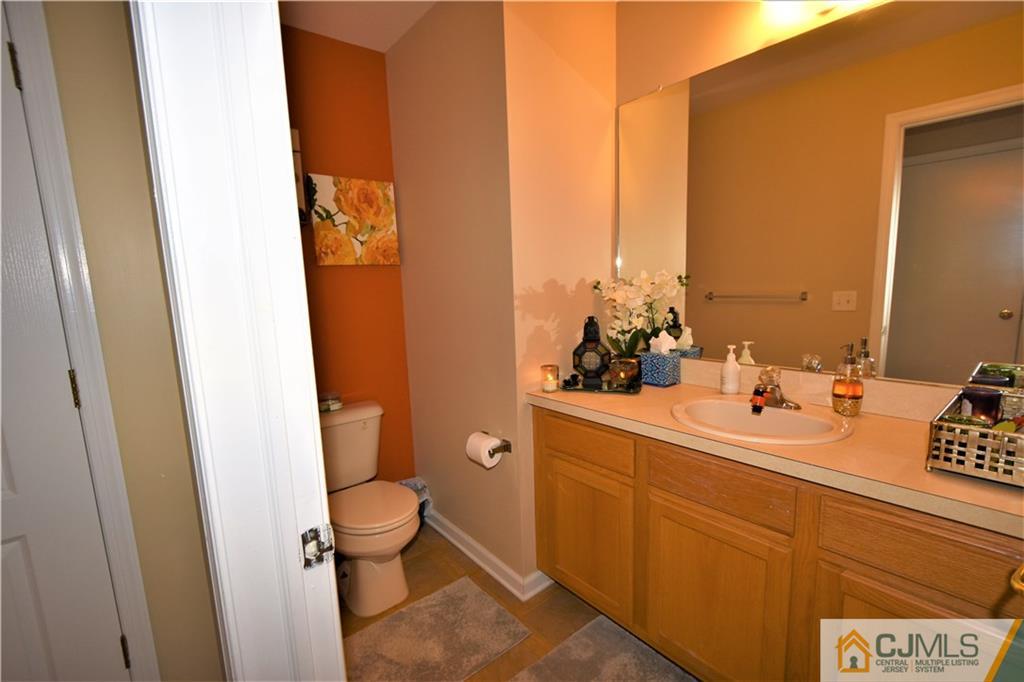 51 Hawthorne Road North Brunswick, NJ 08902 - Photo 11 of 23 a bathroom with a sink and mirror with toilet