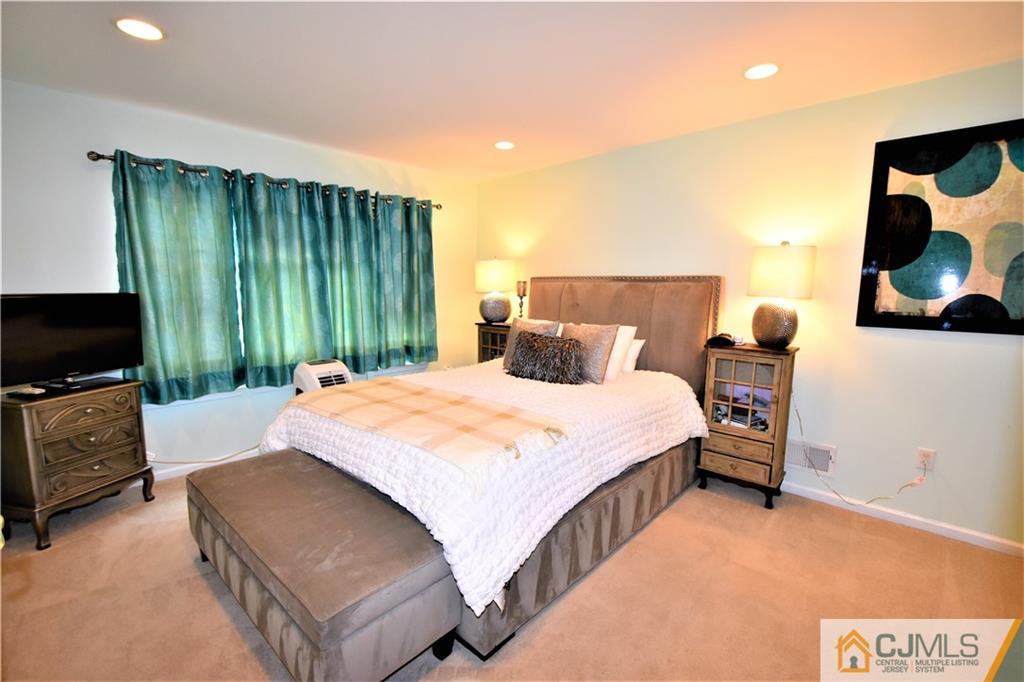 51 Hawthorne Road North Brunswick, NJ 08902 - Photo 12 of 23 a bedroom with a bed and a television