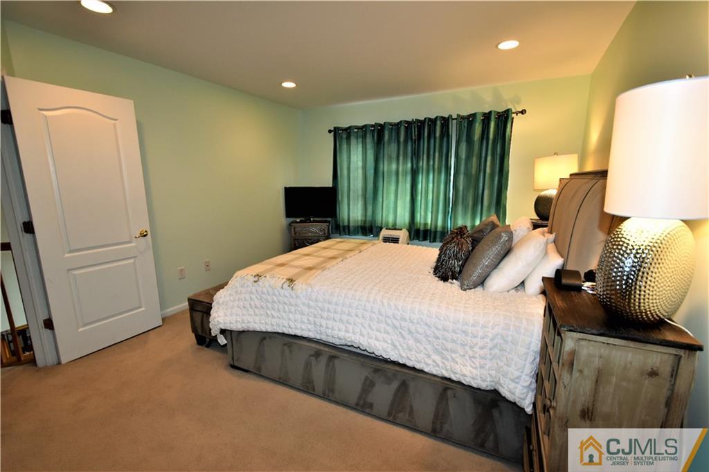 51 Hawthorne Road North Brunswick, NJ 08902 - Photo 13 of 23 a bed sitting in a spacious bedroom next to a window