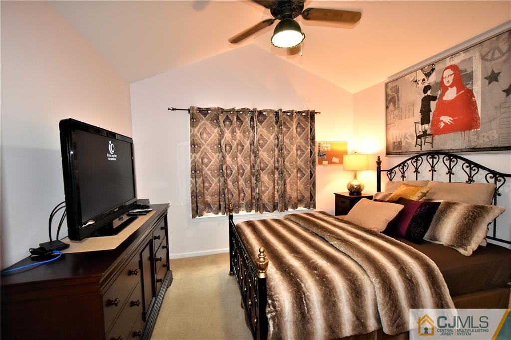 51 Hawthorne Road North Brunswick, NJ 08902 - Photo 15 of 23 a bedroom with a bed and a flat screen tv