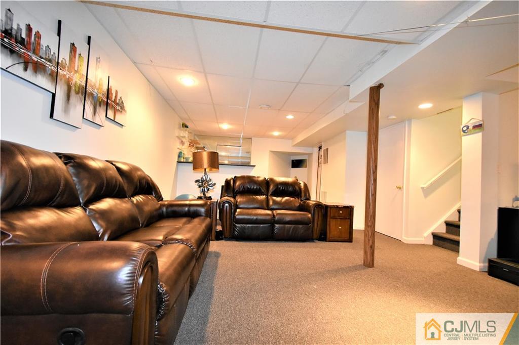 51 Hawthorne Road North Brunswick, NJ 08902 - Photo 19 of 23 a living room with furniture and a flat screen tv