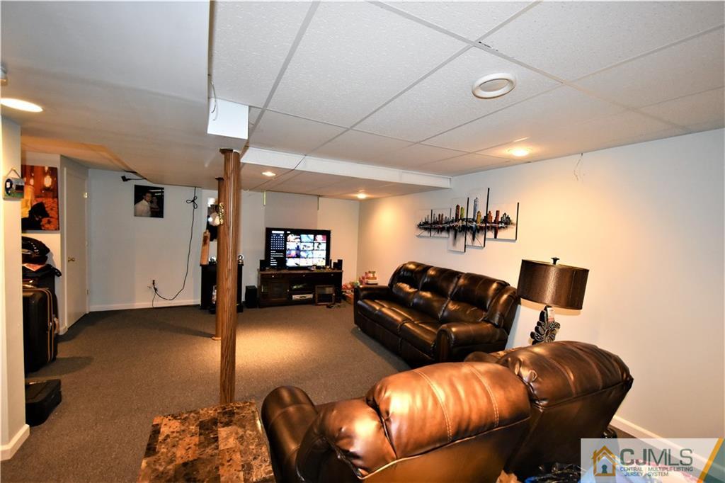 51 Hawthorne Road North Brunswick, NJ 08902 - Photo 20 of 23 a living room with furniture and a flat screen tv