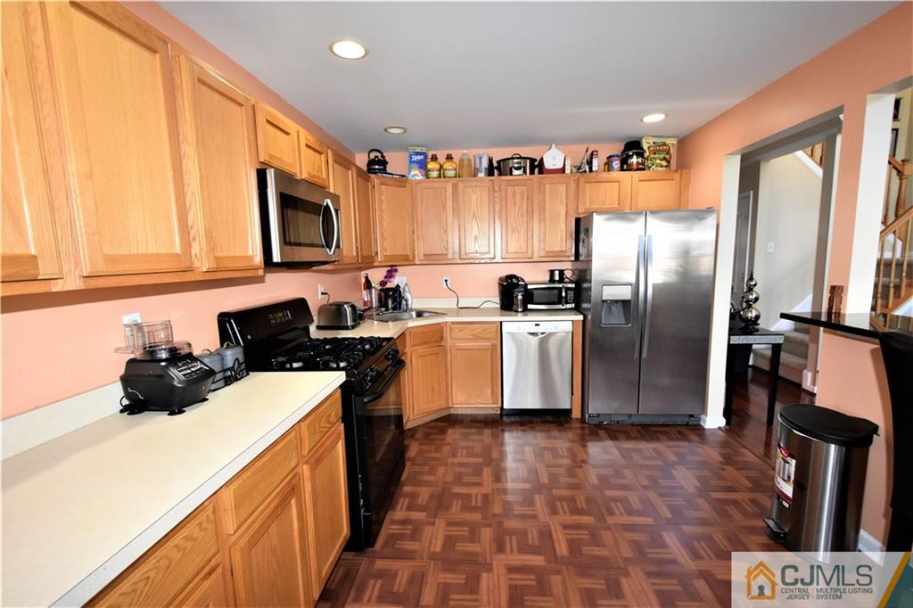 51 Hawthorne Road North Brunswick, NJ 08902 - Photo 9 of 23 a kitchen with stainless steel appliances a refrigerator sink and microwave