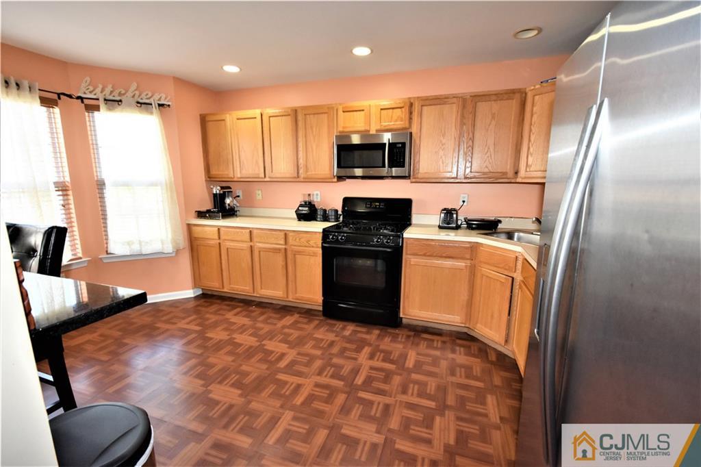 51 Hawthorne Road North Brunswick, NJ 08902 - Photo 10 of 23 a kitchen with stainless steel appliances granite countertop a stove a sink and a refrigerator