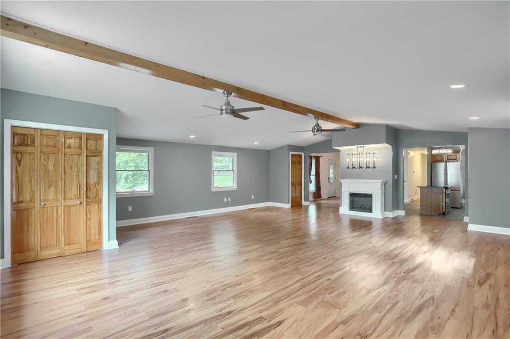 319 Dobson Road Mars, PA 16046 - Photo 12 of 25 an empty room with wooden floor and fireplace