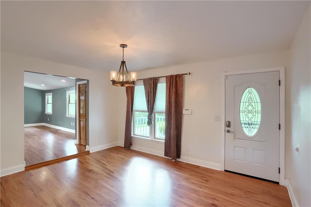 319 Dobson Road Mars, PA 16046 - Photo 3 of 25 an empty room with wooden floor mirror and windows