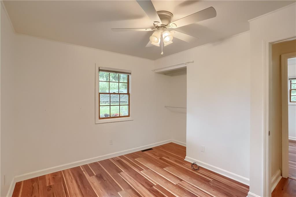 319 Dobson Road Mars, PA 16046 - Photo 21 of 25 an empty room with wooden floor fan and windows