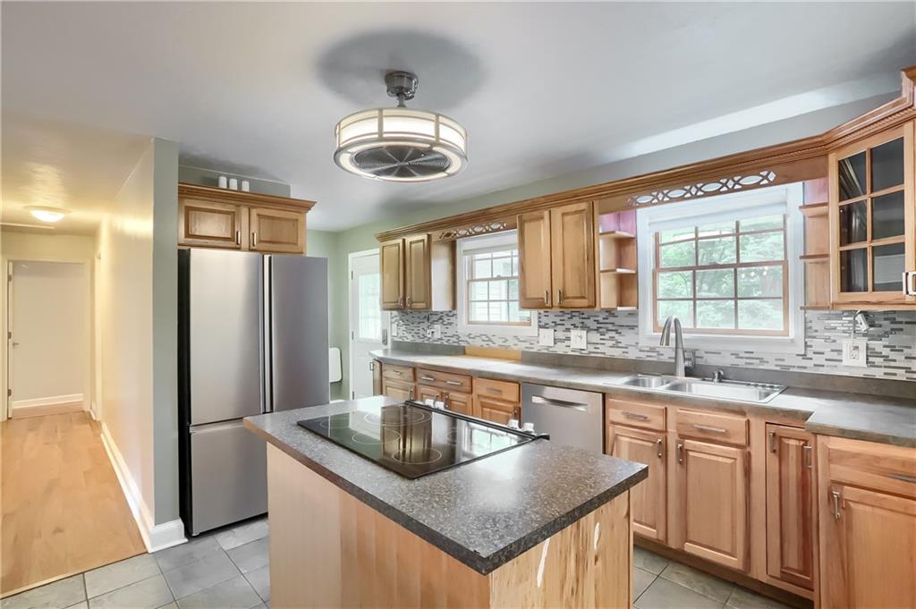 319 Dobson Road Mars, PA 16046 - Photo 5 of 25 a kitchen with stainless steel appliances granite countertop a sink a stove and refrigerator