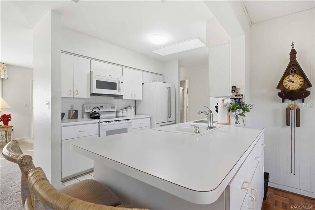 8709 East Sandpiper Drive Inverness, FL 34450 - Photo 7 of 37 a kitchen with a sink a stove and chairs