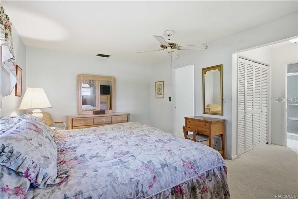 8709 East Sandpiper Drive Inverness, FL 34450 - Photo 8 of 37 a bedroom with a bed and a dresser in it