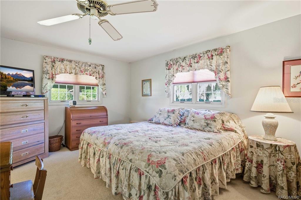 8709 East Sandpiper Drive Inverness, FL 34450 - Photo 9 of 37 a bedroom with a bed and a chandelier