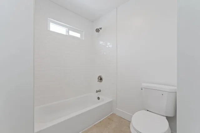 a bathroom with a toilet and a bathtub