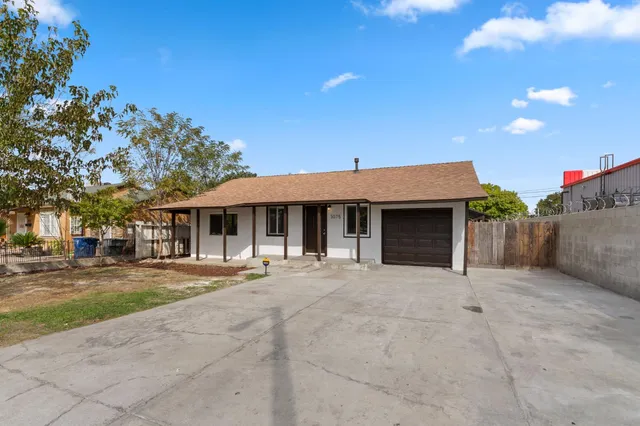 a front view of a house with a yard and a garage