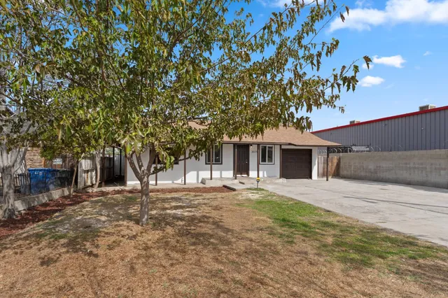 a house that has a tree in front of it