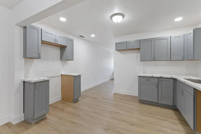 a kitchen with a sink a microwave and cabinets