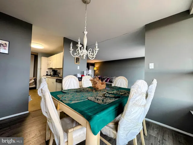 a view of a dining room with furniture wooden floor and chandelier