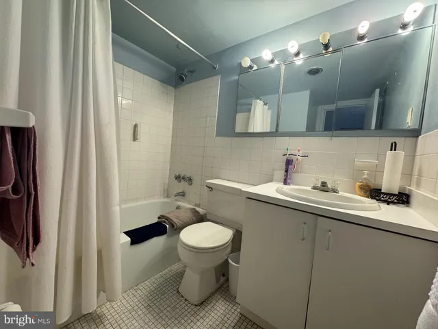 a bathroom with a sink toilet and mirror