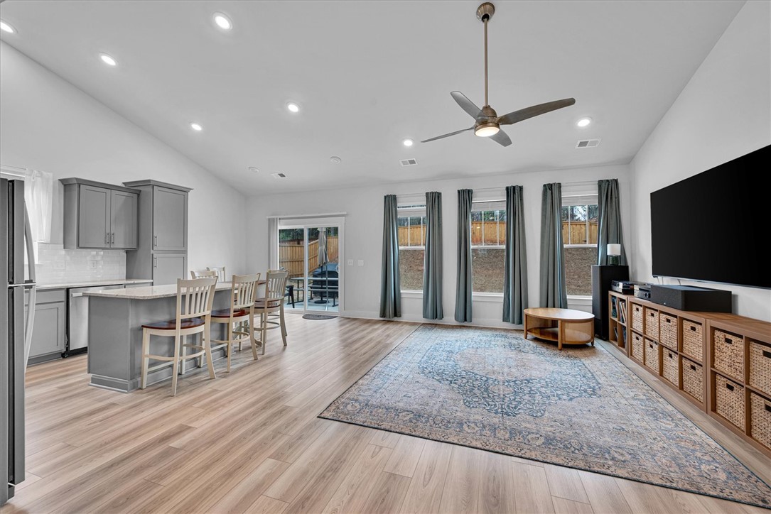 529 Overbrook Drive Seneca, SC 29678 - Photo 5 of 33 An open concept living area with kitchen island seating, ample light, and a view of the outdoors.