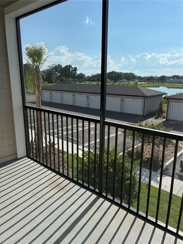 a view of a balcony with wooden floor