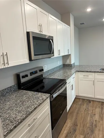 a kitchen with a stove microwave and sink