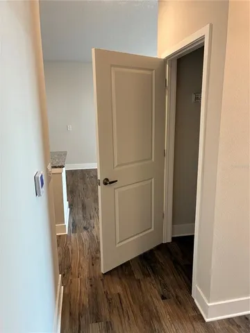 a view of a room with wooden floor