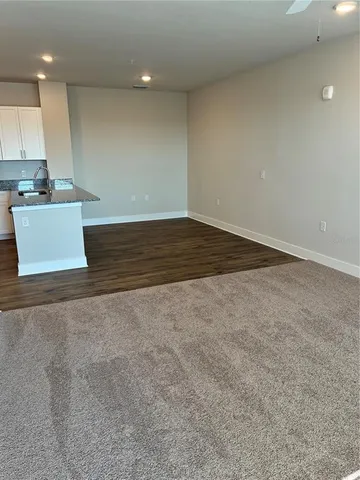 a view of kitchen and empty room