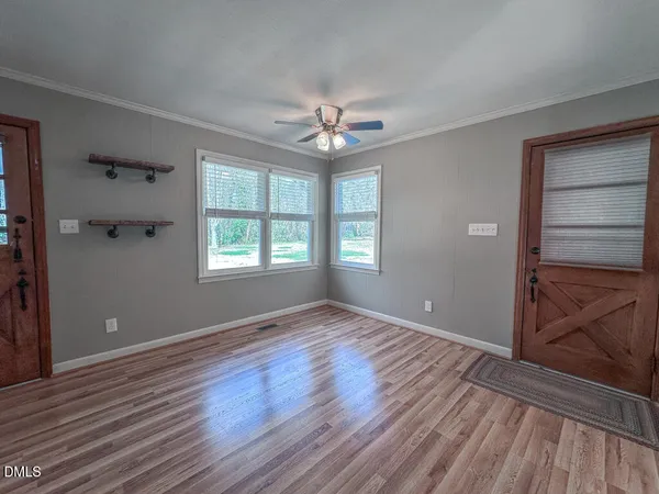 wooden floor in an empty room with a window