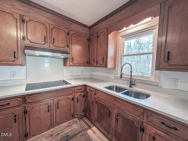 a kitchen with sink cabinets and window