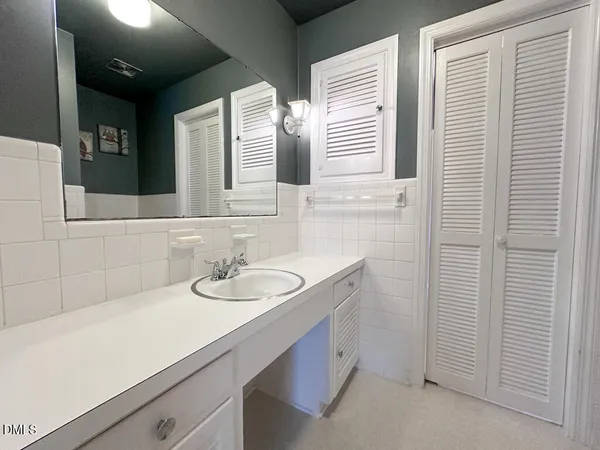 a bathroom with double sink and a mirror