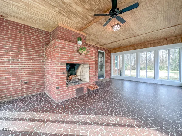 a view of a livingroom with furniture and a fireplace