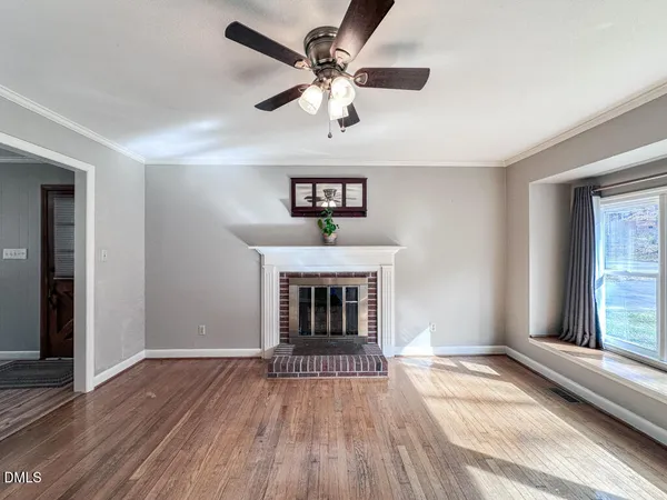 wooden floor fireplace and windows in a room