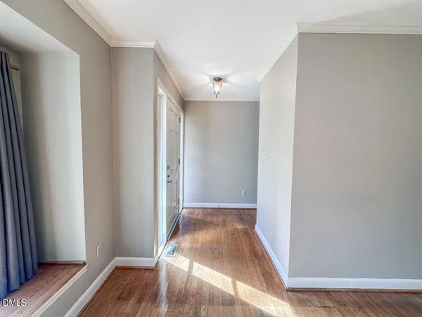 a view of hallway with wooden floor