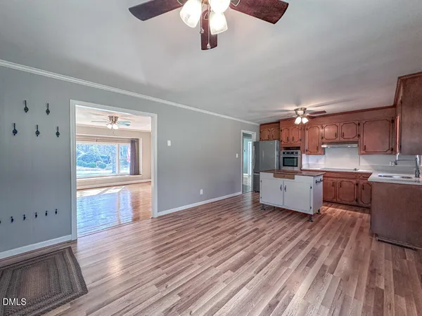 a kitchen with stainless steel appliances kitchen island wooden floors and granite counter tops