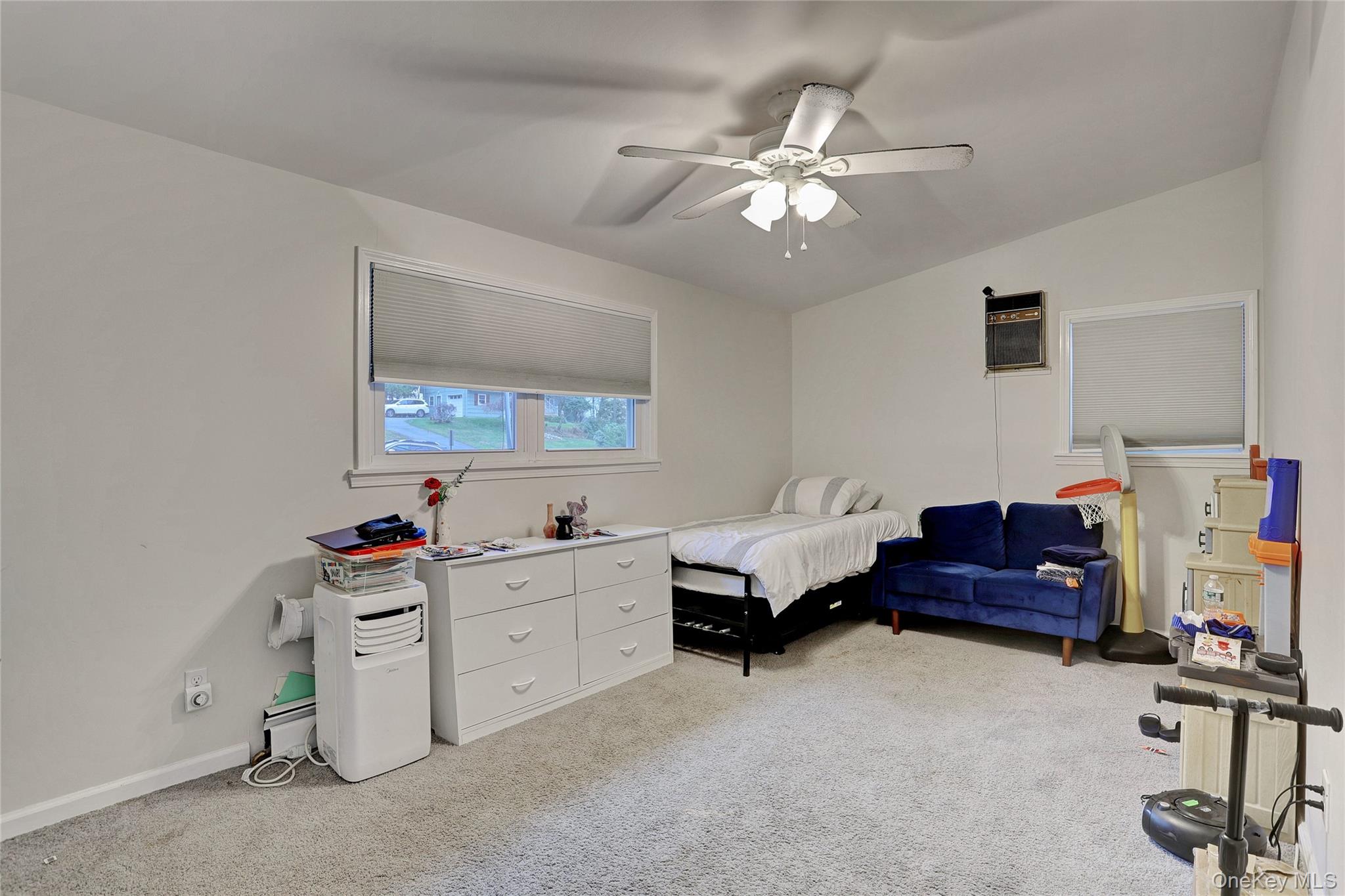 35 Regina Road Monsey, NY 10952 - Photo 16 of 34 Bedroom featuring light carpet, lofted ceiling, and a ceiling fan