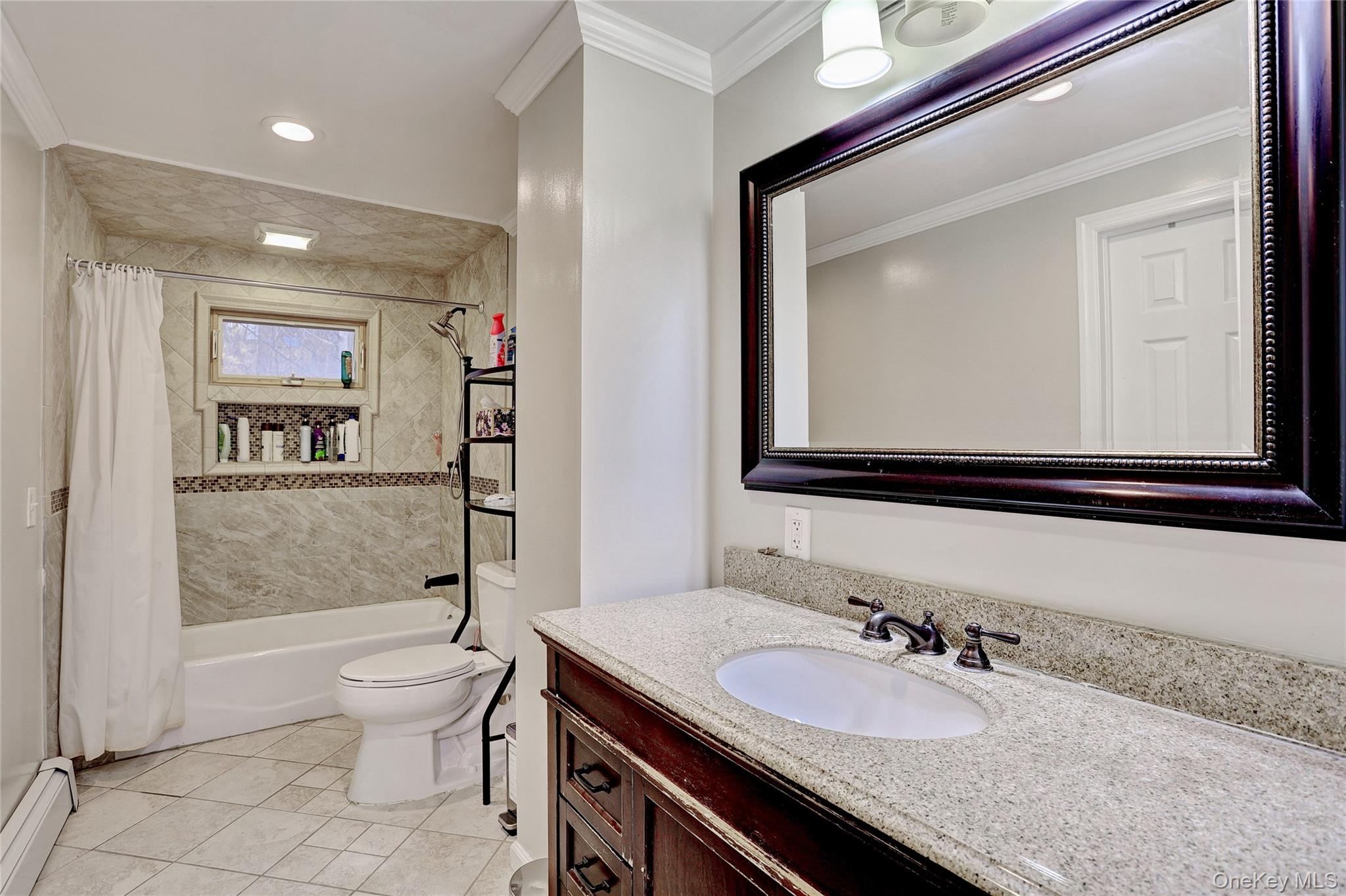 35 Regina Road Monsey, NY 10952 - Photo 18 of 34 Bathroom featuring a baseboard radiator, vanity, crown molding, shower / tub combo, and recessed lighting